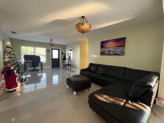a view of a livingroom with furniture and a window