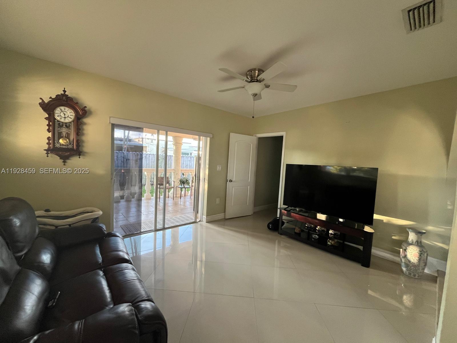3520 Southwest 104th Avenue Miami, FL 33165 - Photo 10 of 38 a living room with furniture and a flat screen tv