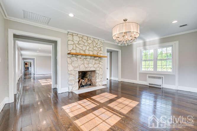 55 Devon Road, Unit B Colonia, NJ 07067 - Photo 12 of 53 wooden floor fireplace and windows in an empty room