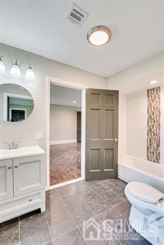 55 Devon Road, Unit B Colonia, NJ 07067 - Photo 14 of 53 a bathroom with a sink a toilet and a mirror
