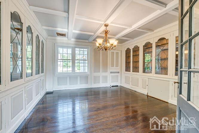 55 Devon Road, Unit B Colonia, NJ 07067 - Photo 19 of 53 a view of an empty room with wooden floor and fan