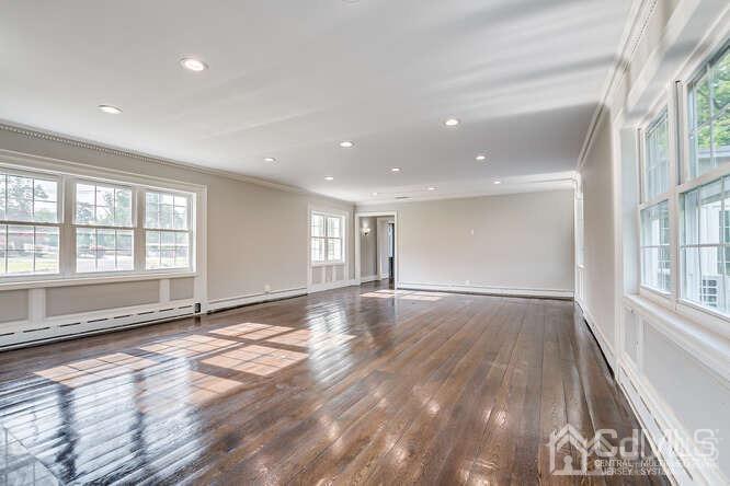 55 Devon Road, Unit B Colonia, NJ 07067 - Photo 27 of 53 a view of an empty room with wooden floor and a window