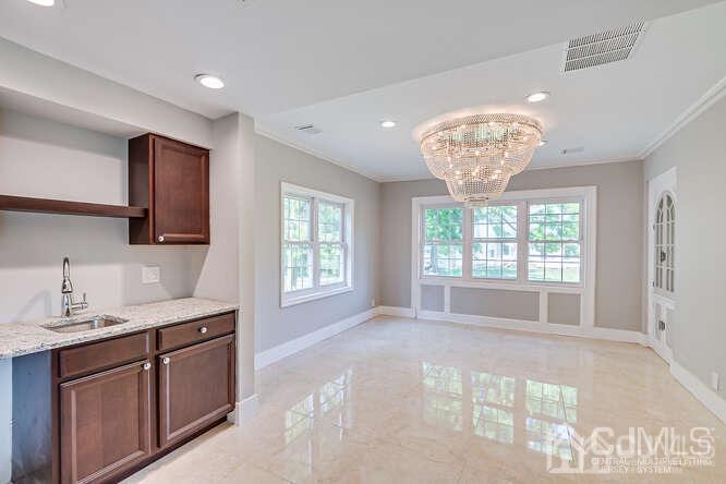 55 Devon Road, Unit B Colonia, NJ 07067 - Photo 30 of 53 a spacious bathroom with a granite countertop sink a large mirror a bathtub and window