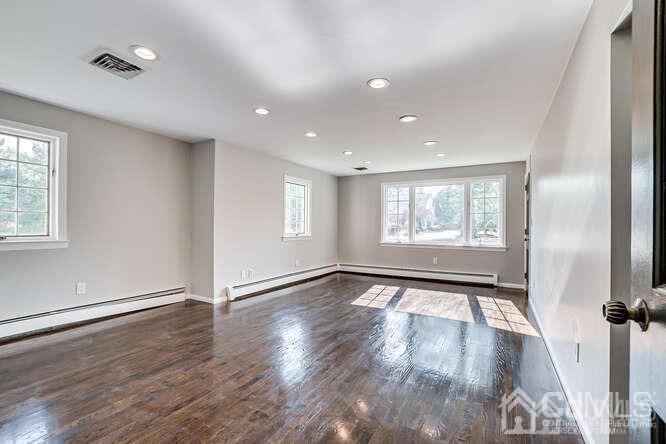 55 Devon Road, Unit B Colonia, NJ 07067 - Photo 32 of 53 an empty room with wooden floor and windows
