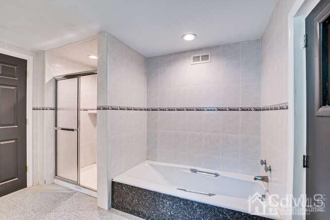 55 Devon Road, Unit B Colonia, NJ 07067 - Photo 34 of 53 a bathroom with a bathtub and a shower