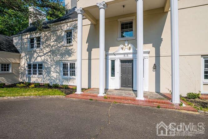 55 Devon Road, Unit B Colonia, NJ 07067 - Photo 4 of 53 a front view of a house with a yard