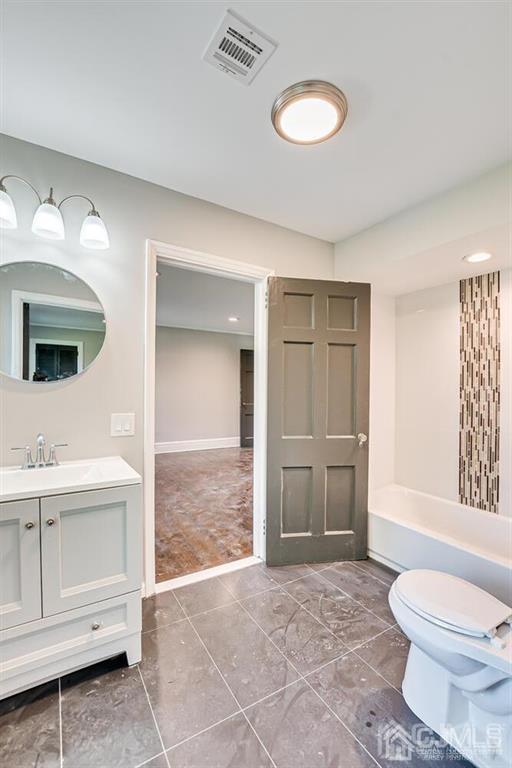 55 Devon Road, Unit B Colonia, NJ 07067 - Photo 42 of 53 a bathroom with a toilet a sink and mirror