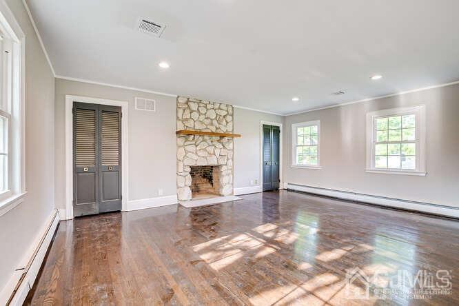 55 Devon Road, Unit B Colonia, NJ 07067 - Photo 44 of 53 an empty room with windows and fireplace