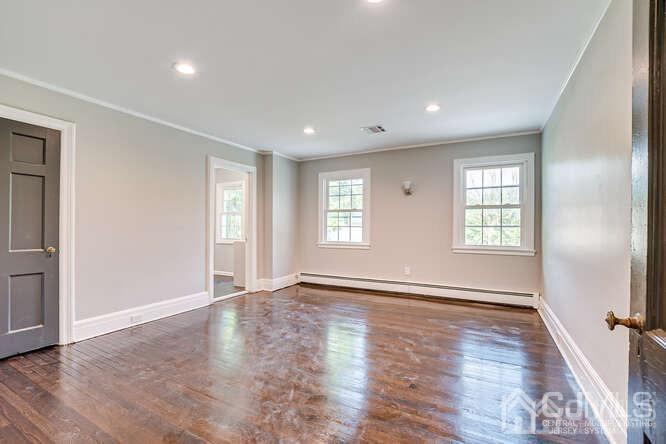 55 Devon Road, Unit B Colonia, NJ 07067 - Photo 45 of 53 an empty room with wooden floor and windows