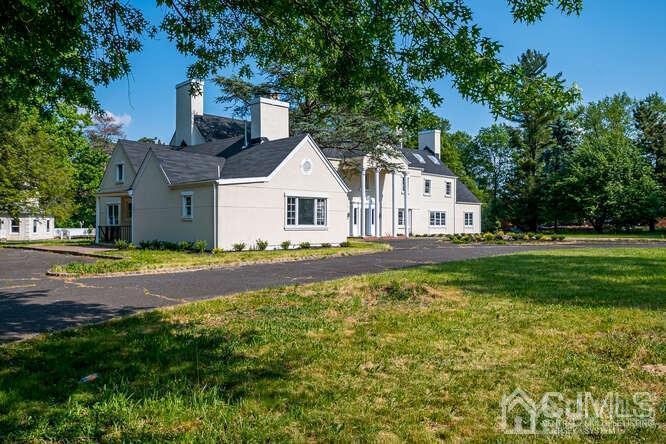 55 Devon Road, Unit B Colonia, NJ 07067 - Photo 50 of 53 a view of a house with a big yard and large trees