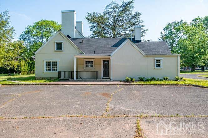 55 Devon Road, Unit B Colonia, NJ 07067 - Photo 52 of 53 a front view of a house with a garden and yard