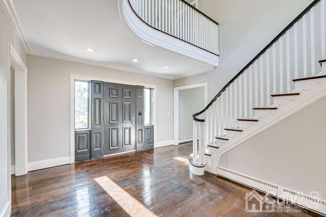 55 Devon Road, Unit B Colonia, NJ 07067 - Photo 7 of 53 a view of entryway with wooden floor