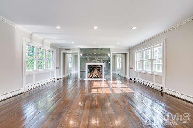 55 Devon Road, Unit B Colonia, NJ 07067 - Photo 10 of 53 wooden floor in an empty room with a window