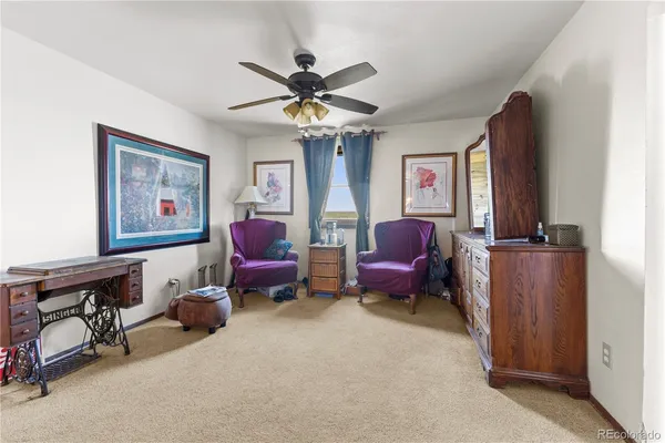 a living room with furniture a chandelier and a window