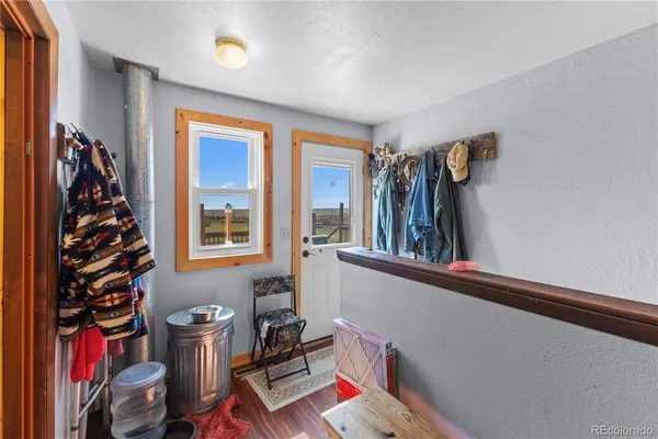 a view of a room with lots of stuff and hardwood floor