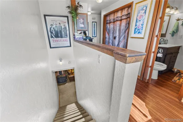 a view of stairs with furniture and wooden floor