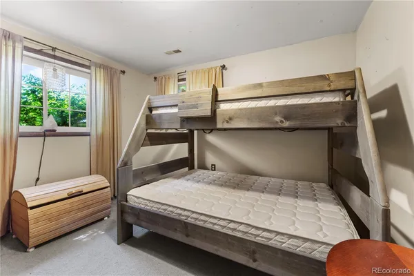 a bedroom with a bed and large window