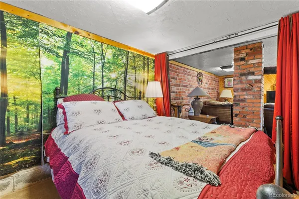 a bed sitting in a bedroom next to a window