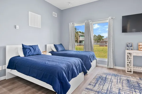 a bedroom with a bed and a television