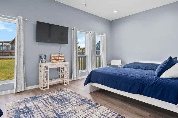 a bedroom with a bed and a television