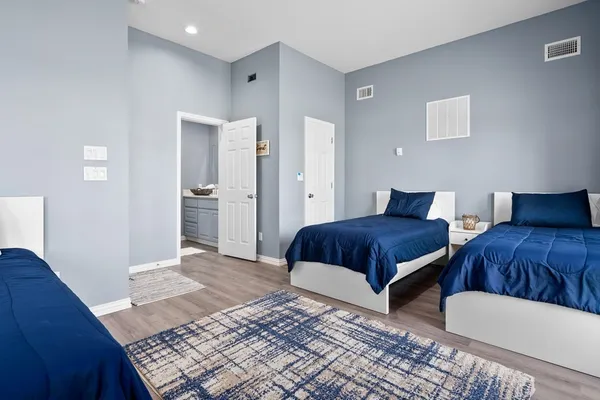 a bedroom with bed and a night stand