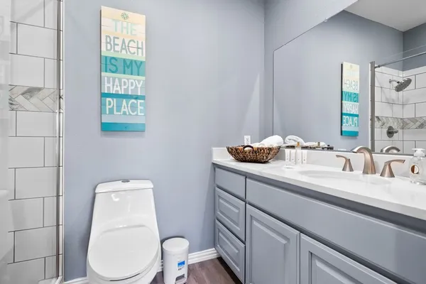 a bathroom with a toilet sink and mirror