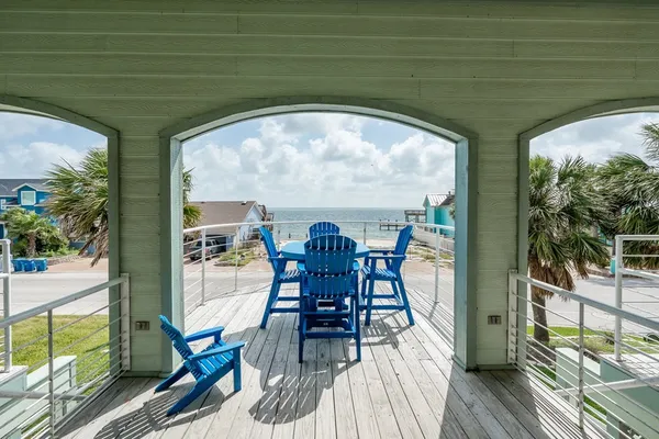 a view of a chairs and table in the balcony