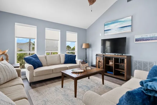 a living room with furniture and a flat screen tv