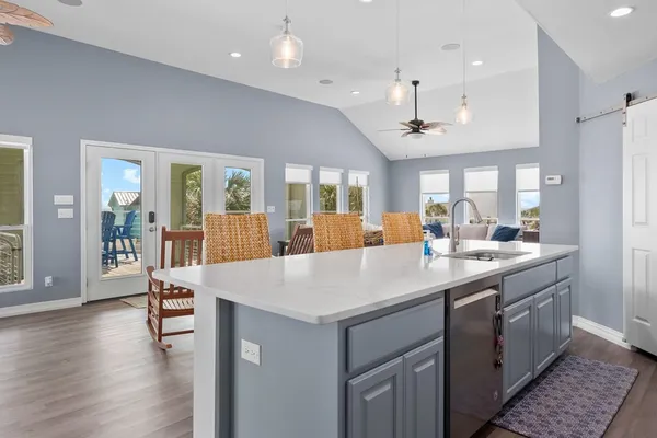 a large kitchen with a table and chairs