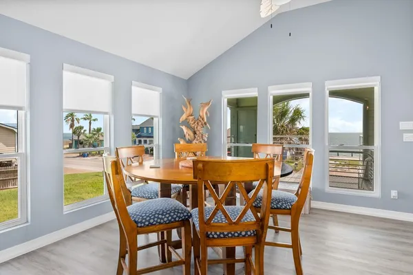 a view of a dining room with furniture and wooden floor