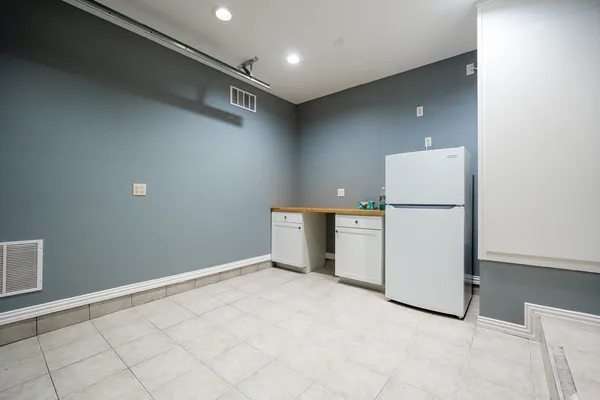 a view of a storage & utility room with two washing machine