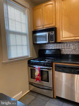 a kitchen with stainless steel appliances granite countertop a stove and a microwave