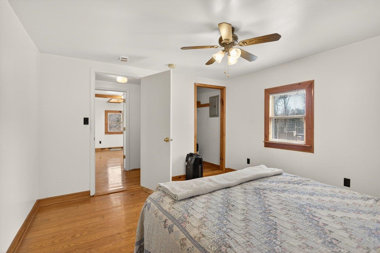 10677 Allman Road Dayton, VA 22821 - Photo 21 of 57 a bedroom with a bed and a chandelier