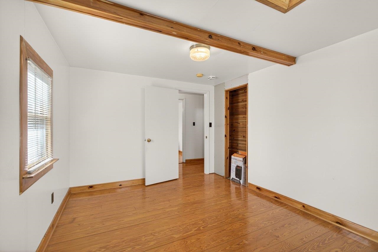 10677 Allman Road Dayton, VA 22821 - Photo 23 of 57 a view of an empty room with wooden floor and a window
