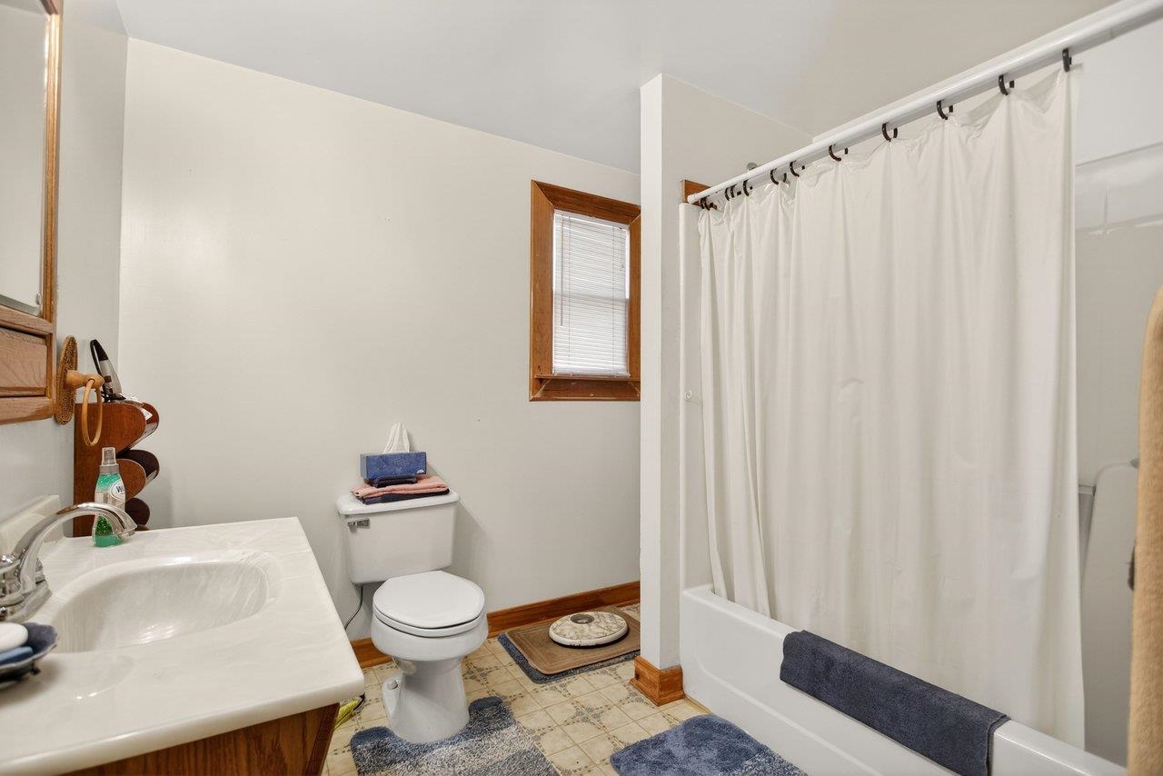 10677 Allman Road Dayton, VA 22821 - Photo 25 of 57 a bathroom with a sink a toilet and shower curtain