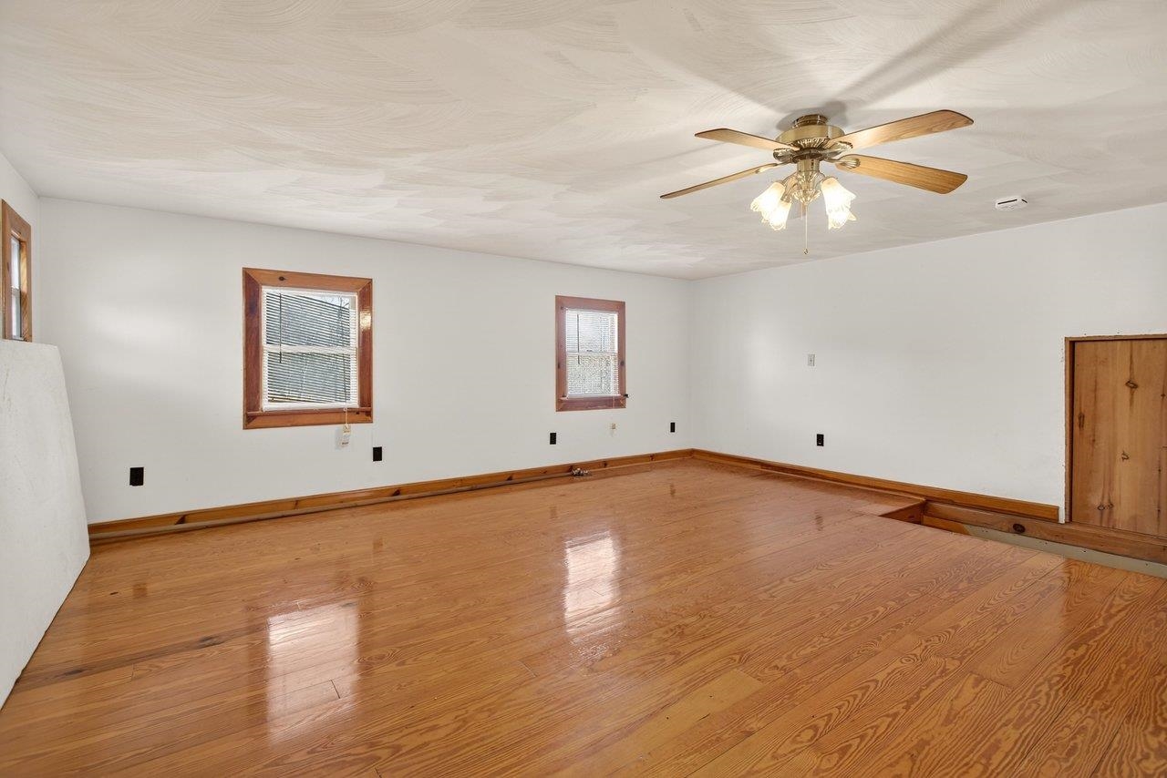 10677 Allman Road Dayton, VA 22821 - Photo 28 of 57 a view of an empty room with chandelier fan and wooden floor