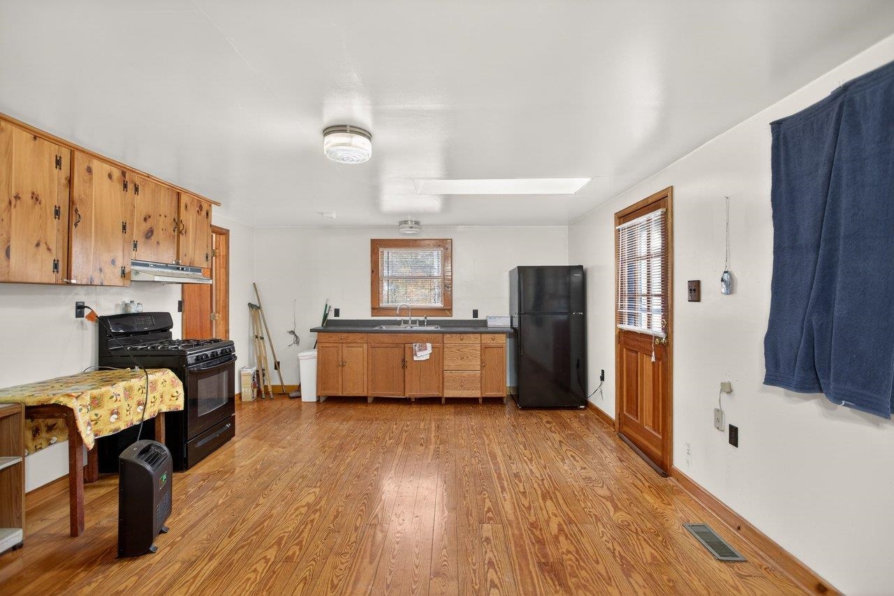 10677 Allman Road Dayton, VA 22821 - Photo 4 of 57 a kitchen with stainless steel appliances wooden floors and refrigerator