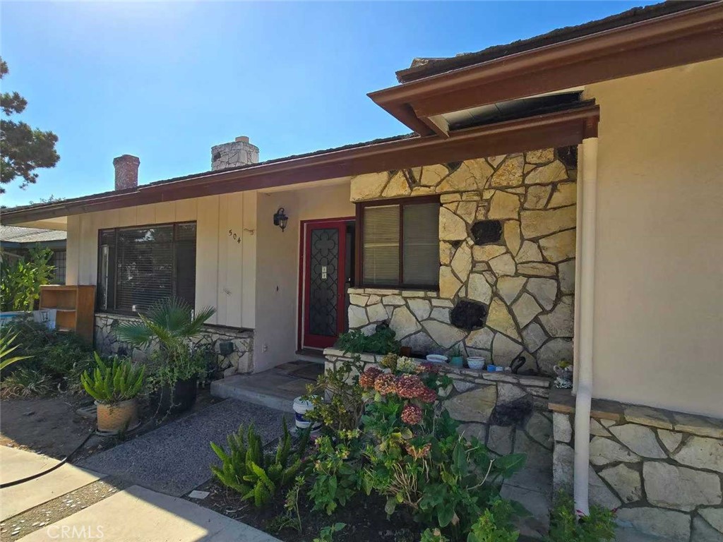 front view of a house with potted plants