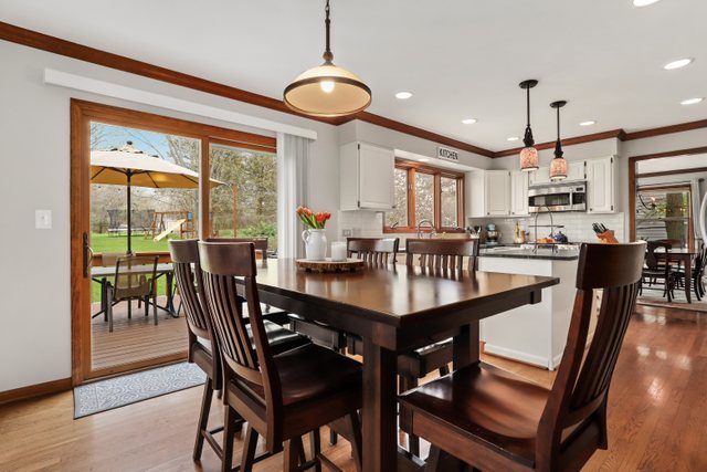 982 Plum Tree Road Fox River Grove, IL 60021 - Photo 12 of 48 a view of a dining room with furniture window and wooden floor