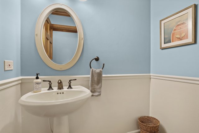 982 Plum Tree Road Fox River Grove, IL 60021 - Photo 21 of 48 a bathroom with a sink and a mirror