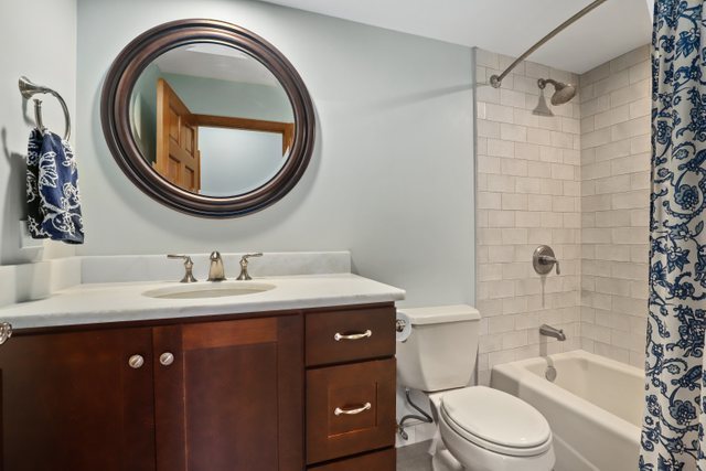 982 Plum Tree Road Fox River Grove, IL 60021 - Photo 28 of 48 a bathroom with a sink a toilet and a mirror