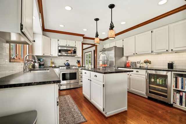 982 Plum Tree Road Fox River Grove, IL 60021 - Photo 10 of 48 a kitchen with stainless steel appliances granite countertop a stove a sink and a refrigerator