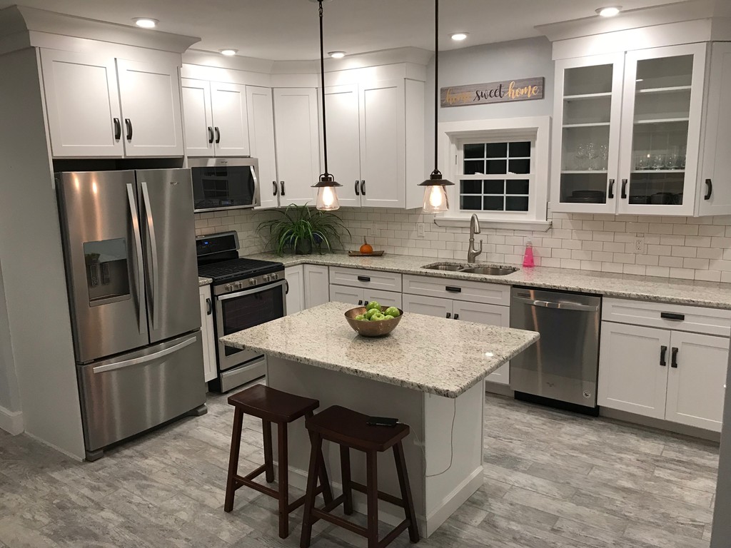 18 Park Street Boston, MA 02136 - Photo 1 of 20 a kitchen with stainless steel appliances a sink a stove a refrigerator and cabinets
