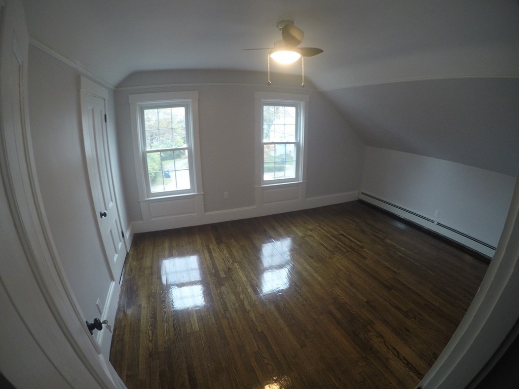 18 Park Street Boston, MA 02136 - Photo 14 of 20 an empty room with wooden floor and windows