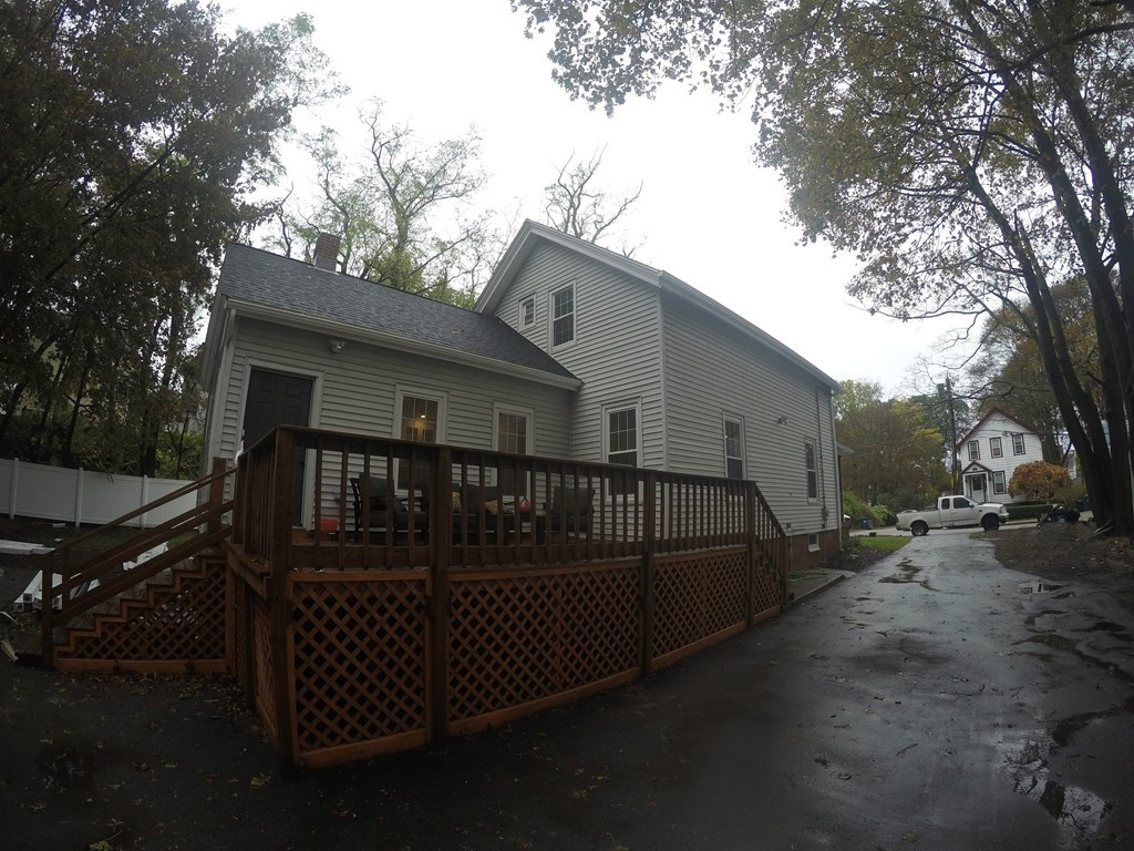 18 Park Street Boston, MA 02136 - Photo 19 of 20 a view of a house with wooden deck and trees