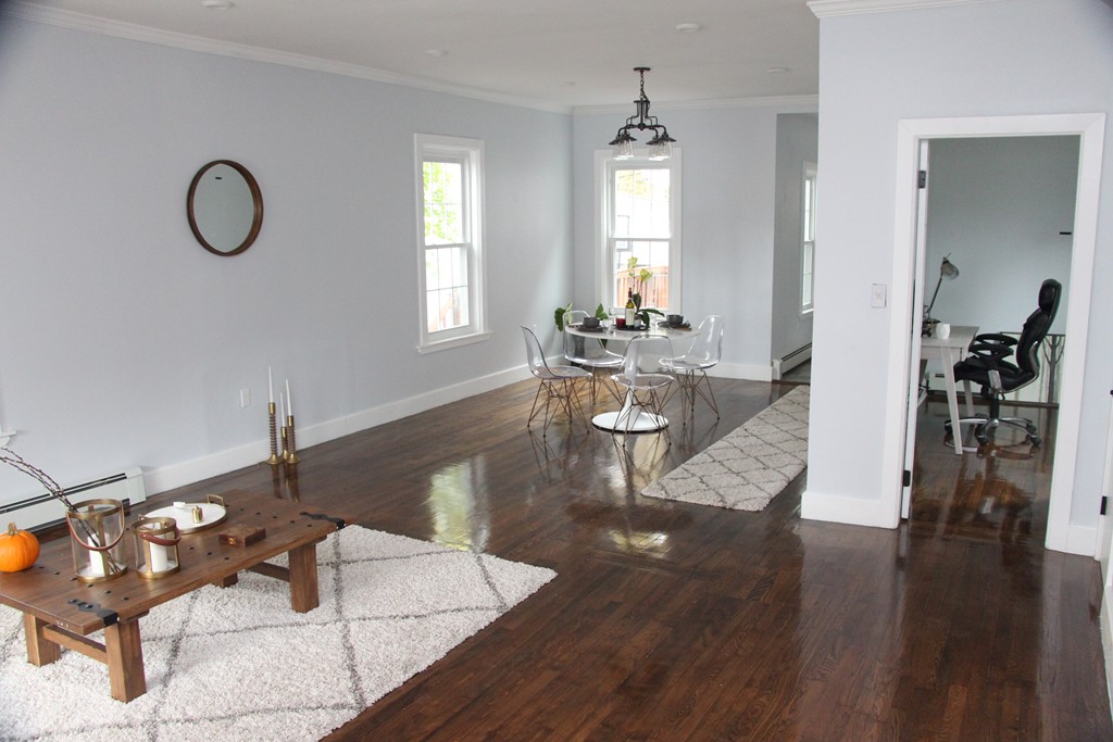 18 Park Street Boston, MA 02136 - Photo 8 of 20 a living room with couches chairs with a dining table and wooden floor