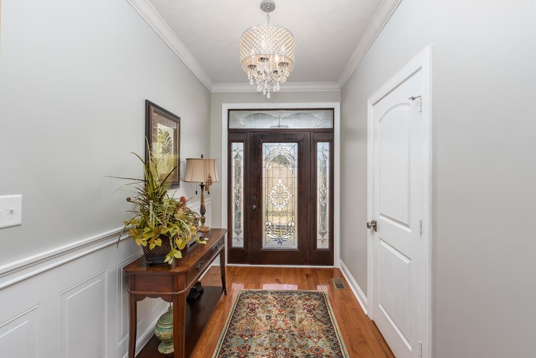 230 Koogler Trail Raphine, VA 24472 - Photo 19 of 61 a hallway with painting and a chandelier