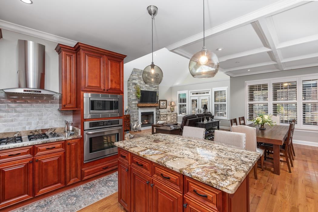 230 Koogler Trail Raphine, VA 24472 - Photo 29 of 61 a large kitchen with granite countertop a stove oven and a view of living room