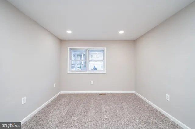 a view of a big room with wooden floor and windows in a room