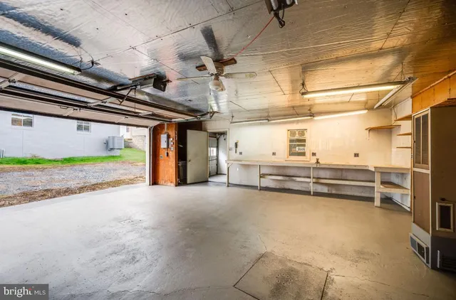 an empty room with fireplace and wooden floor